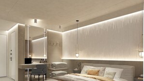 A modern bedroom with a large bed, a desk, and a mirror. - Core Hotel (Kassandra)