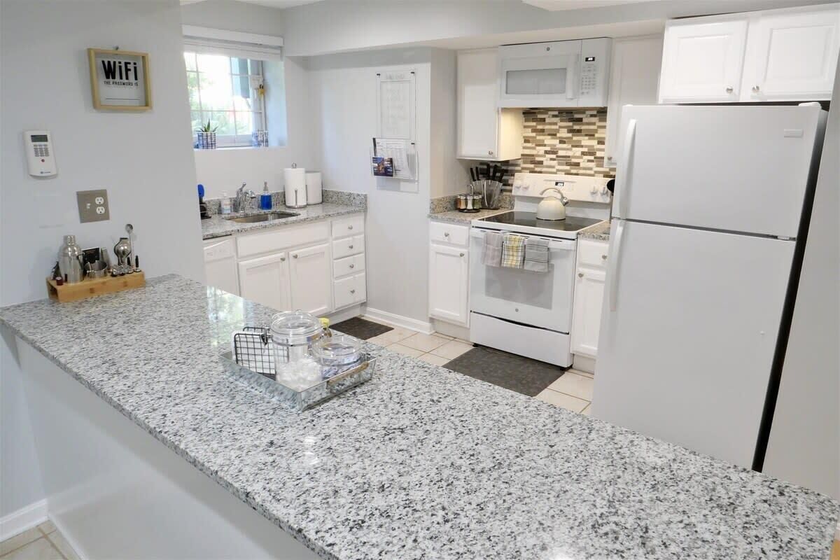 Fridge, microwave, coffee/tea maker, cookware/dishes/utensils
