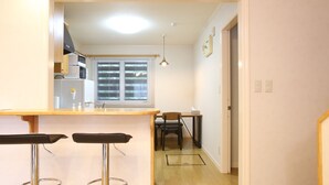 Una cocina con barra, una mesa de comedor y sillas.