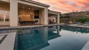 A modern house with a swimming pool, outdoor seating, and a patio area. - Luxury Retreat w/Views: Putting Green/Game Room/Infinity Pool & More! (Escondido)