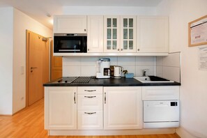 Réfrigérateur, four à micro-ondes, surface de cuisson, cafetière-théière