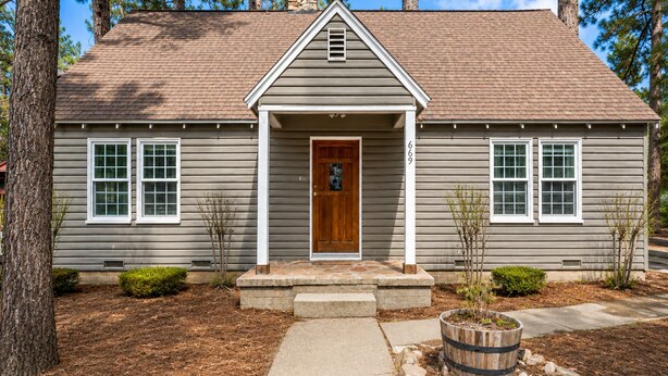 A two-story house with a front porch, a stone chimney, and a mailbox. - Country Bear Inn - Game Room, Pool Table, Barbecue (Big Bear City)