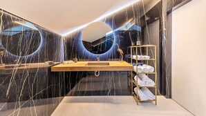 A modern bathroom with a marble vanity, a large mirror, and a towel rack. - Studio Apartment 'App 303 Palazzo Cavour' with Mountain View, Wi-Fi and Air Conditioning (Bolzano)