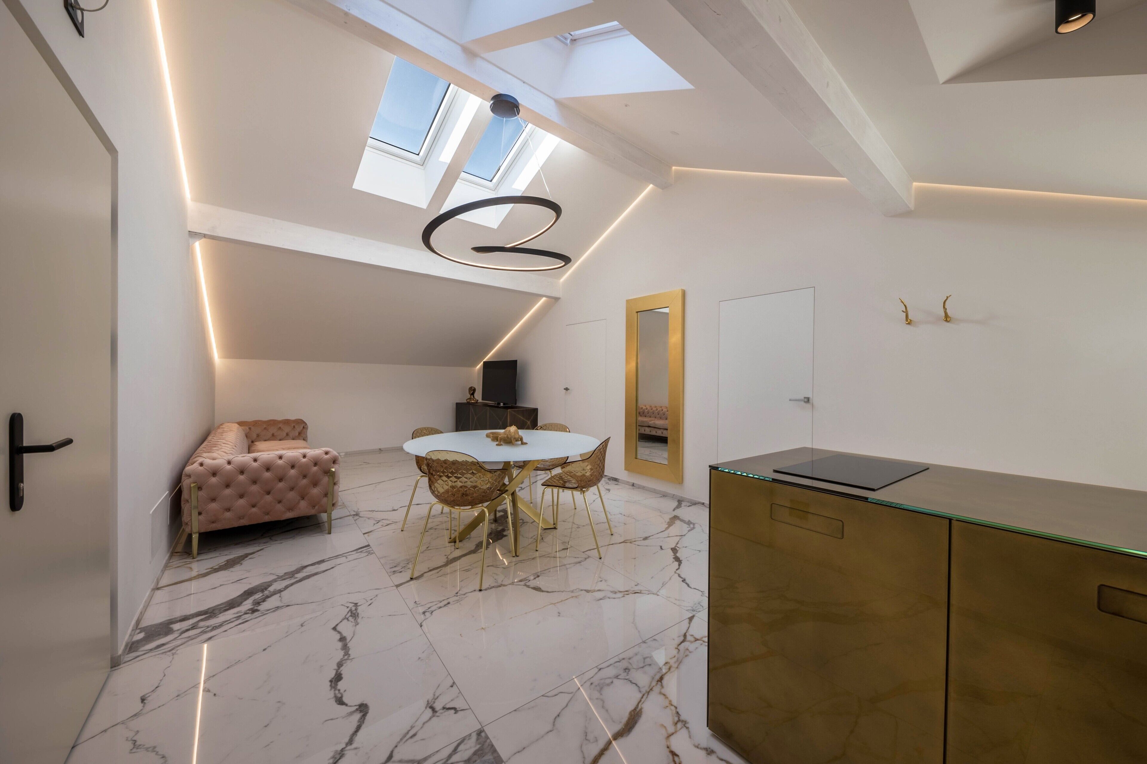 A modern interior with a marble floor, a round dining table, a sofa, and a glass cabinet.
