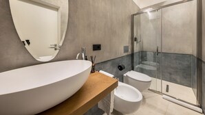 A modern bathroom with a large oval sink, a glass-enclosed shower, and a toilet. - Apartment 'App 202 Palazzo Cavour' with Mountain View, Wi-Fi and Air Conditioning (Bolzano)