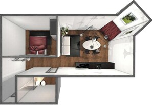 Une chambre d’hôtel de taille réduite comprenant un lit, une petite kitchenette, un coin repas et une salle de bain.