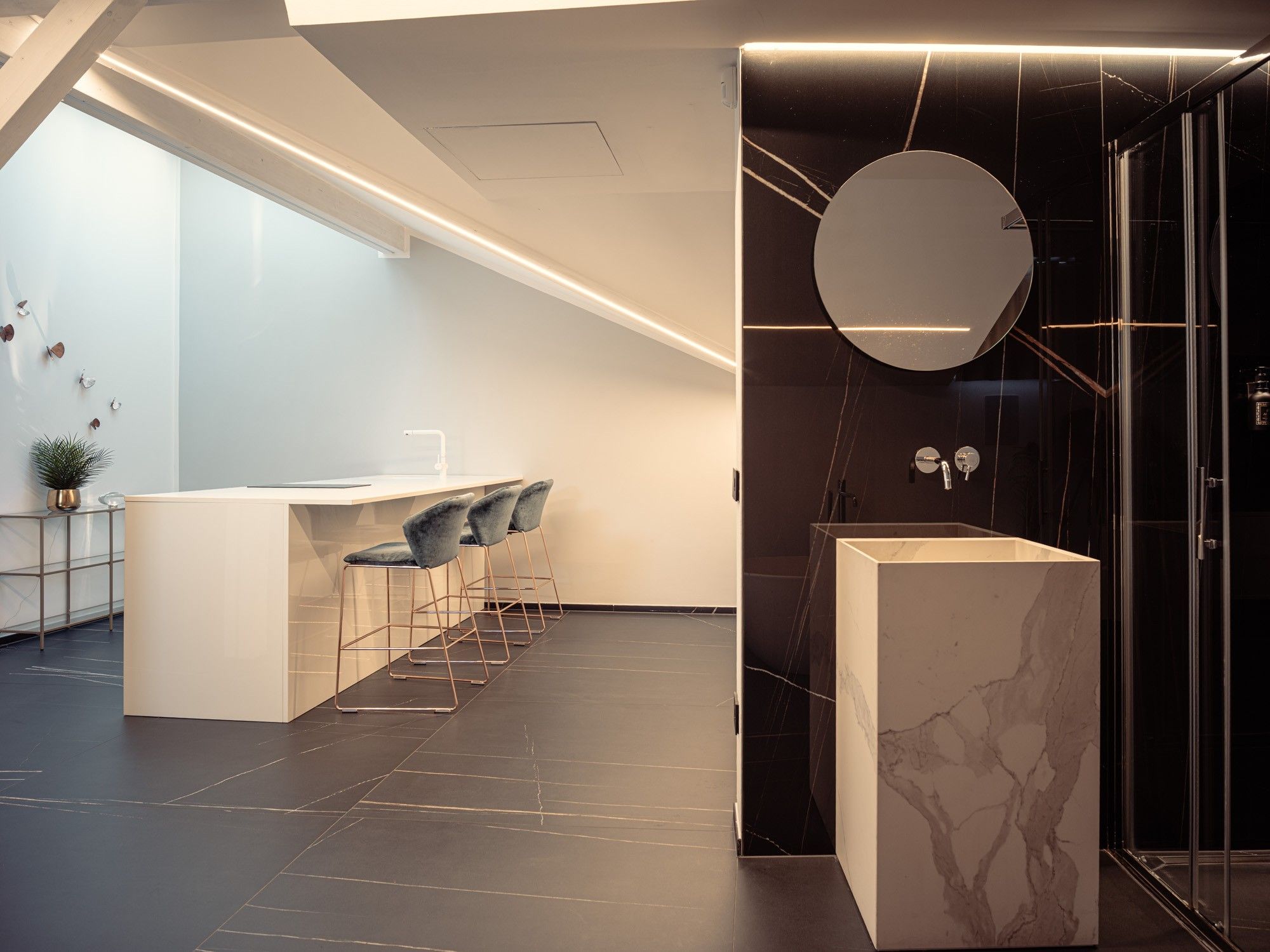 A modern bathroom with a marble sink, a glass shower enclosure, and a minimalist design.