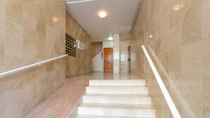 A clean, modern interior with a marble staircase, a handrail, and a tiled floor. - Beautiful Vacation Hom "Mtsrat8 "e with Air Conditioning & Terrace (Torrevieja)