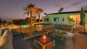 A rooftop patio with outdoor seating, a satellite dish, and a green umbrella. - Villa Ginevra, perfect for large groups, with Pool, Sauna & Garden (Arona)