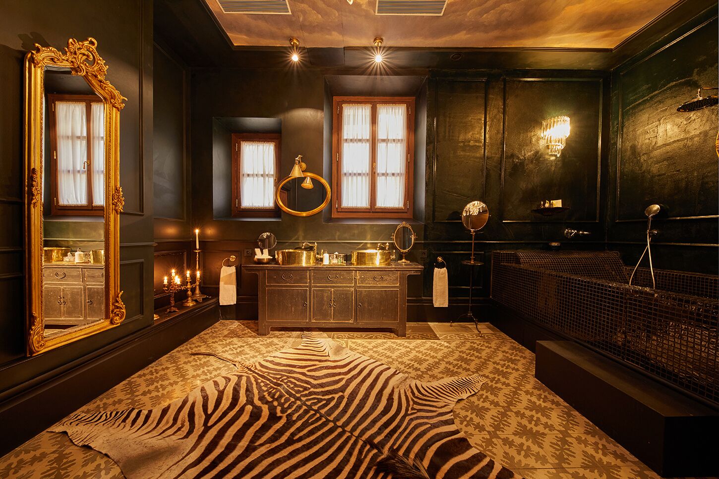 A luxurious bathroom with a large mirror, vanity, and a zebra-patterned rug.
