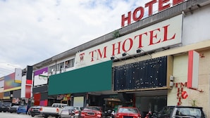 A hotel with a prominent sign reading "TM HOTEL" and a large green awning. - OYO 90345 TM Hotel (Taman Melawati)