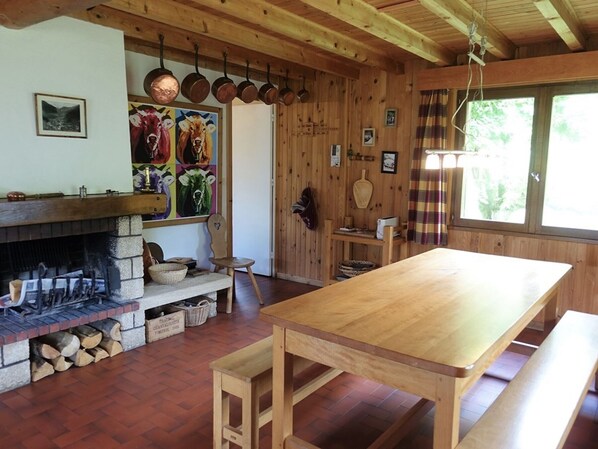A rustic wooden interior with a fireplace, wooden benches, and a long table. - Cozy chalet for 10 with fireplace and internet, close to slopes (Arêches-Beaufort)