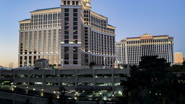 A large, multi-story hotel with a prominent tower and a casino sign. - SVS: Modern 3BD Strip View Condo | 1,000+ sqft | Sleeps 12 | Jockey Club (Las Vegas)