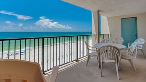 A balcony with a view of the beach and ocean. - Orange Beach Gulf-View 2BR • Sleeps 8 • Wet Bar • Kid-Friendly • Pools • Boats (Orange Beach)