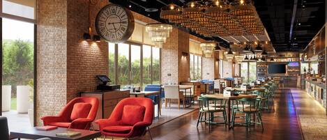 A spacious bar area with wooden flooring, red and green chairs, and a large clock on the wall.