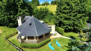A house with a sloped roof, a covered porch, and a fenced yard.