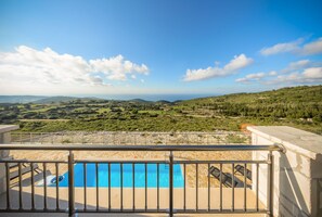 A balcony with a pool overlooking a scenic landscape. - Orient Villas Traditional (Zakynthos)