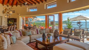 A spacious living area with a large sofa, a coffee table, and a view of the ocean. - Above Villa Paloma Blanca I Pool/Spa I Beach Club I Views I Spa (LA CRUZ DE HUANACAXTLE)