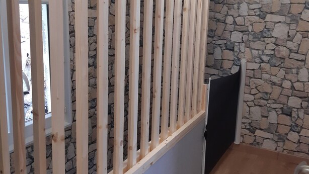 A room with a stone wall, a wooden partition, and a window. - "Les 4 Fils Aymon" House overlooking the Meuse. (Bogny-sur-Meuse)