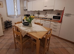 Enjoy meals in this kitchen with a stove, microwave, and dishwasher, and dine at the wooden table for two.