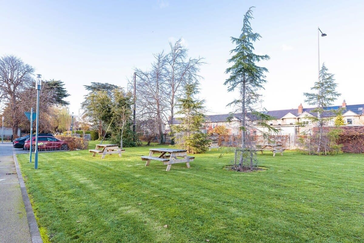 A park with picnic tables and a playground.