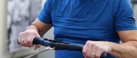 A person using a rowing machine in a gym setting.
