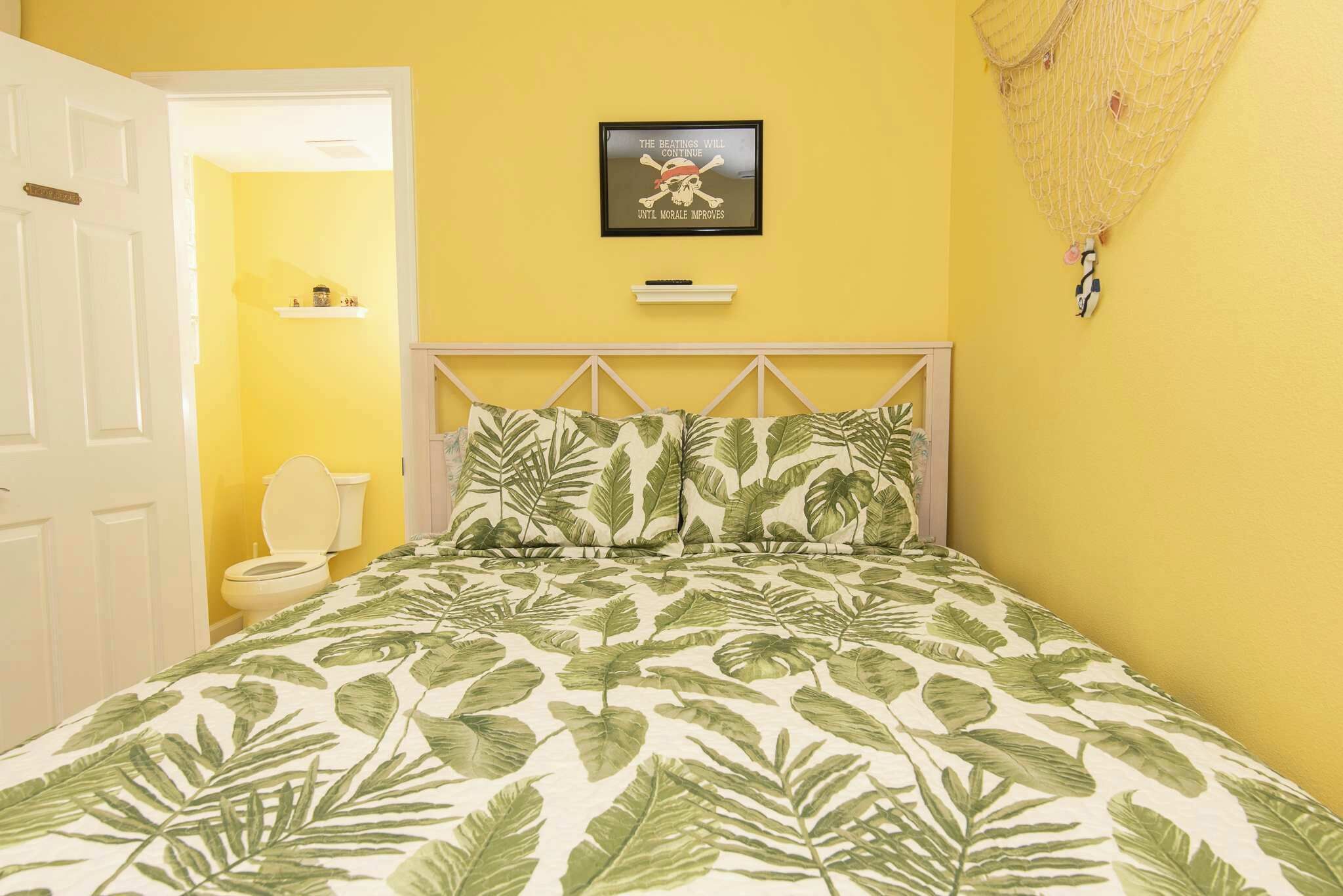 A bedroom with a bed, a toilet, and a door.