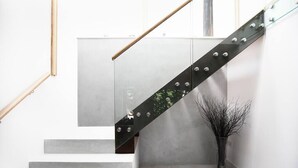 A modern staircase with metal railings and a minimalist design. - The Pole Barn -Stunning High Spec Barn Conversion (Winford)