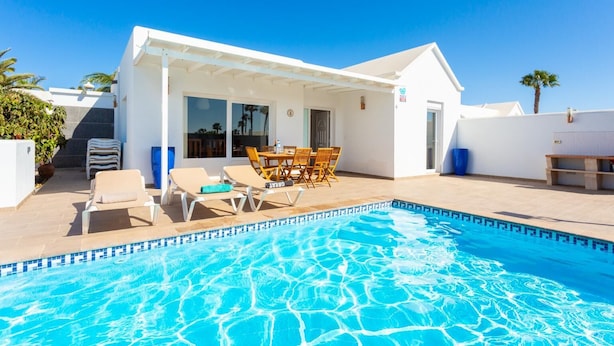 A modern house with a swimming pool, outdoor seating, and a covered patio area. - Villa Diego - Five Bedroom Villa, Sleeps 10 (Puerto del Carmen)