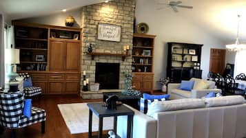 Smart TV, fireplace, books, computer monitors