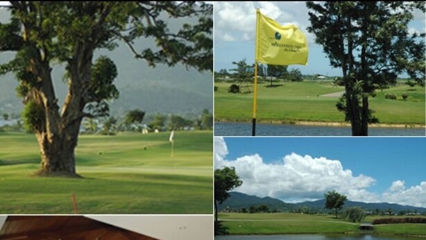 A golf course with a flag, a lake, and a restaurant with outdoor seating. - Cozy 2 Bedroom Apt near Airport, Malls, Golfing, Mountains  (Arouca)