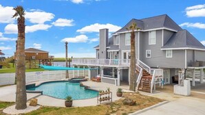 A two-story house with a swimming pool, a covered patio, and a deck. - Luxury Beach Estate Ocean view, Pool, 360° Deck&Beach Access 20%off last minute  (Surfside Beach)