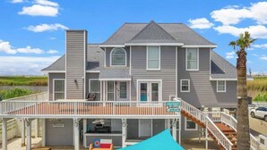 A two-story house with a balcony, a garage, and a sign indicating it is for rent. - Luxury Beach Estate Ocean view, Pool, 360° Deck&Beach Access 20%off last minute  (Surfside Beach)