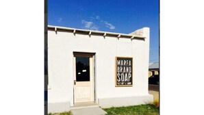 A building with a sign that reads "MARFA BRAND SOAP".