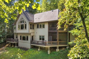 A two-story house with a balcony and a deck.