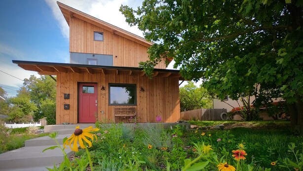 A wooden house with a red door, a small window, and a mailbox. - Clean, one bedroom, newly constructed home within walking distance of downtown.  (Bozeman)