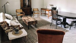 A living room with a sofa, two chairs, a coffee table, a cabinet, and a dining table. - Kennerdell Country Retreat with seasonal inground pool (Kennerdell)