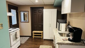 A compact kitchen with a stove, oven, sink, and cabinets. - Comfortable private unit with hot tub, swimming pool and free parking (Gibsonia)