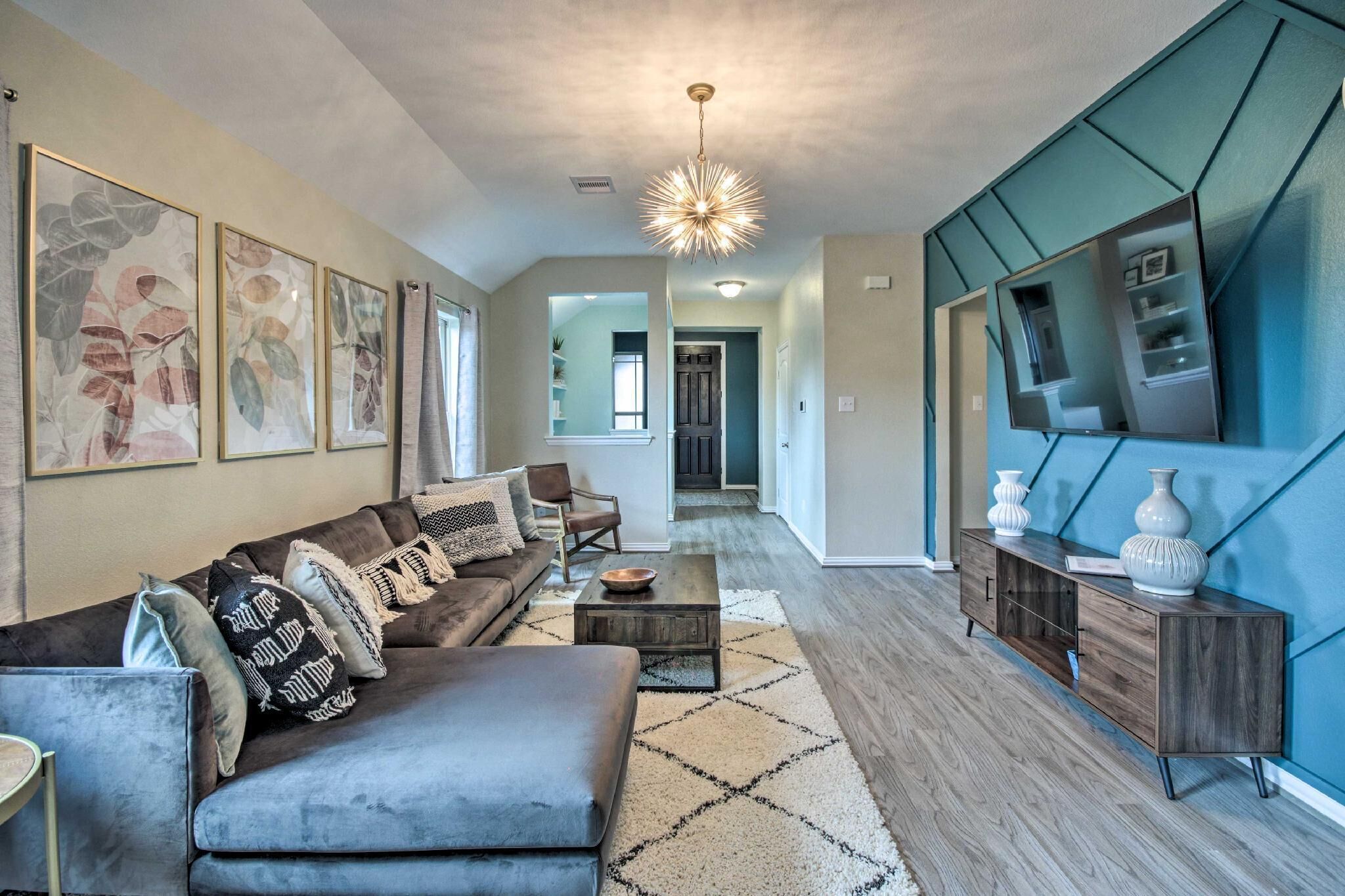Cozy and stylish open concept living room. Enjoy the Smart tv  w/Netflix, Disney and Hulu.  Games and books provided for your entertainment (stored in coffee table).