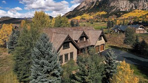 A mountain cabin with a steep roof, surrounded by trees and a clear sky. - Fairway to Heaven-Luxury at Club of CB, Hot tub! (Crested Butte)