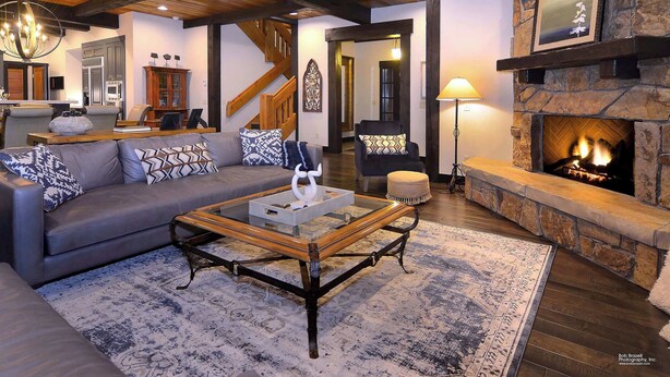 A cozy living room with a fireplace, a sofa set, and a coffee table. - Fairway to Heaven-Luxury at Club of CB, Hot tub! (Crested Butte)
