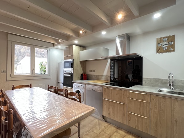 A kitchen with wooden cabinets, a built-in oven, a microwave, a dishwasher, and a sink.