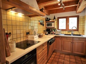 A kitchen with a microwave, toaster, sink, and wooden cabinets.