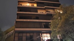 A multi-story building with balconies and windows.