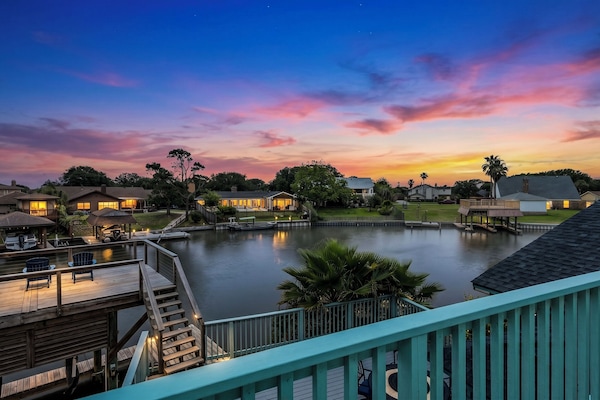 Sunset over Madeline Lake from Lakeview Landing's private dock — moments like this are why guests return to this Galveston waterfront home year after year.