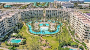 A resort with multiple buildings, a central pool area, and a view of the ocean. - SANDPIPER PH02- 3BR PENTHOUSE @ DESTIN WEST-WHAT A VIEW!! (Fort Walton Beach)