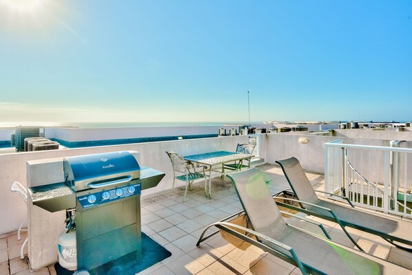 A rooftop terrace with a barbecue grill, outdoor seating, and a view of the sea. - SANDPIPER PH02- 3BR PENTHOUSE @ DESTIN WEST-WHAT A VIEW!! (Fort Walton Beach)