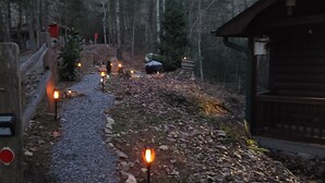 A forest path with a wooden fence and a small cabin. - "  Lazy Bears Cabin" Located in Cherry Log
Highly Rated  overall by Guest (Blue Ridge)