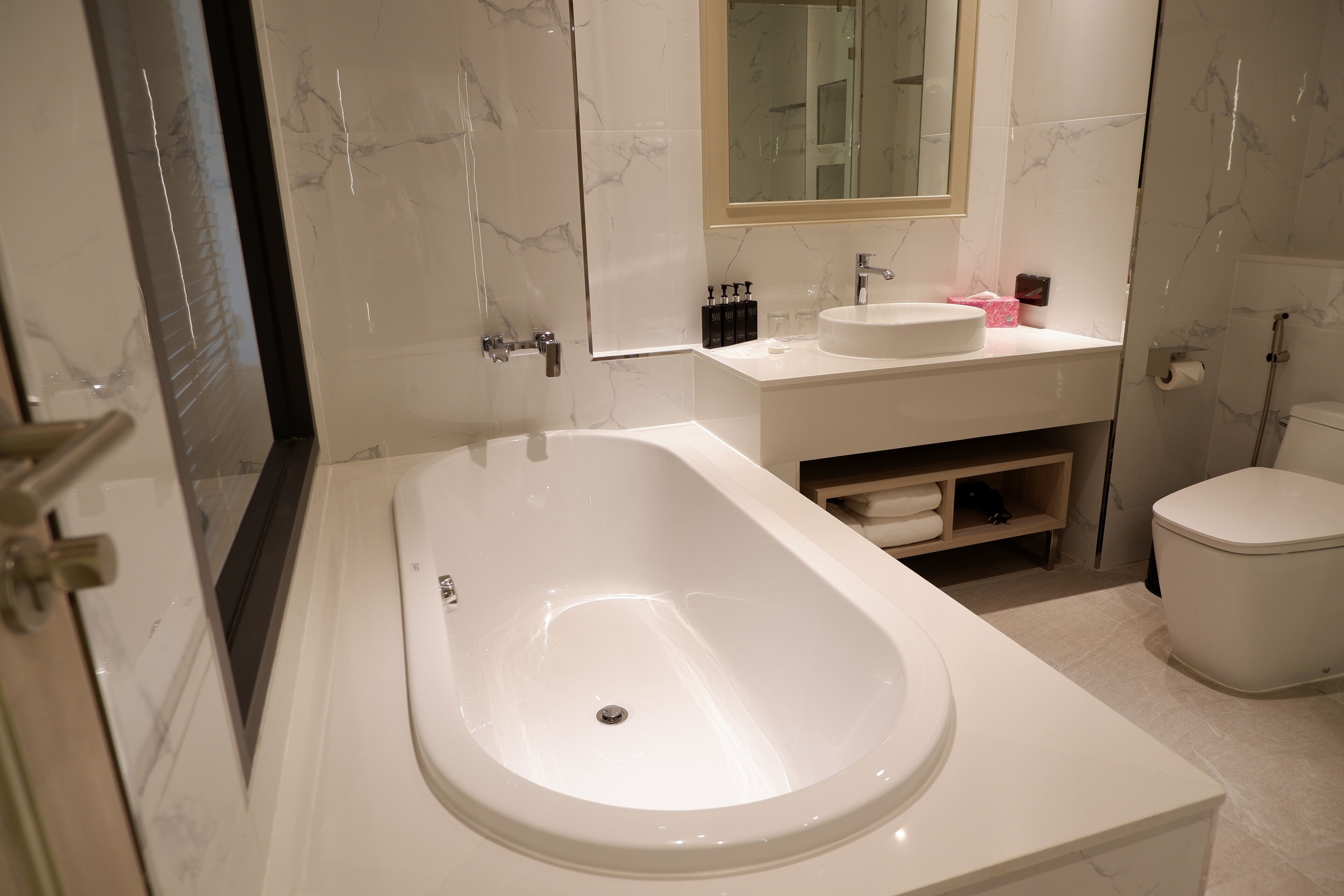 A modern bathroom with a freestanding bathtub, a sink, and a toilet.