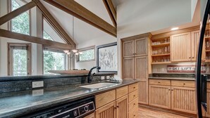 A kitchen with wooden cabinets, a granite countertop, a dishwasher, and a built-in oven. - Luxury 4 Bed Pines Townhome Amongst The Peace And Quiet 4 Bedroom Townhouse by RedAwning (Avon)